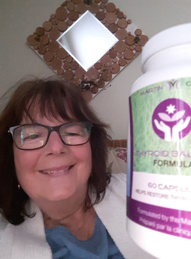 Martin Clinic customer holding Thyroid Support Formula