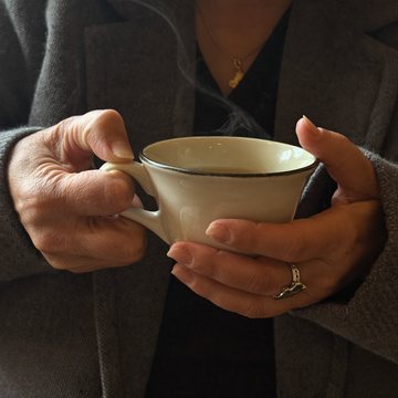 Hands wrapped around a warm mug